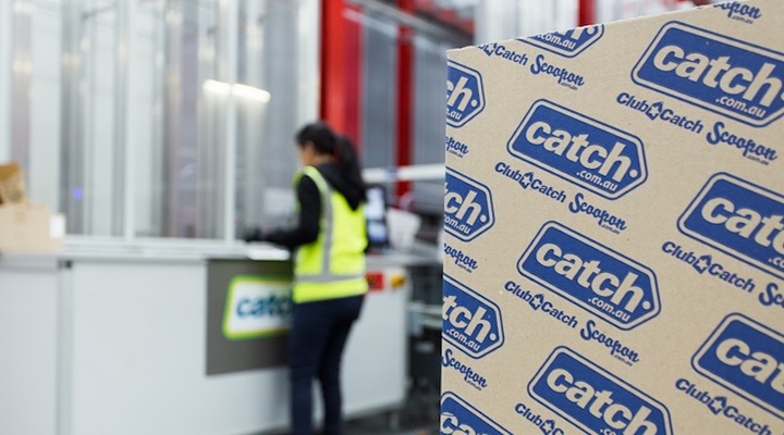 Woman standing in a warehouse, with a package with Catch branding in the foreground