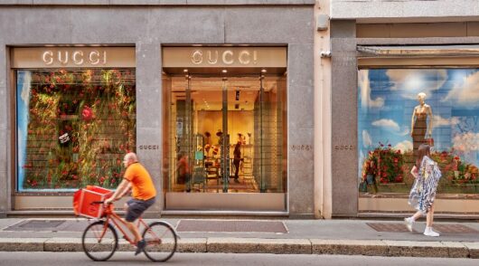 A Gucci store front with a cyclist at the front.