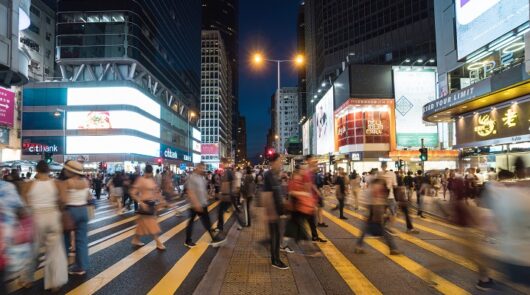 Image of people at night in Hong Kong