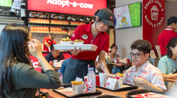 Chick-fil-A staff serving food to customers at the pop-up store in Singapore.