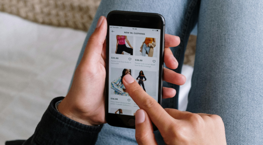 An image of a consumer shopping for fashion on a smartphone