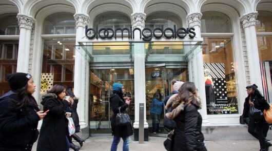 People walk in front of Bloomingdale’s - Macy's upscale department store chain