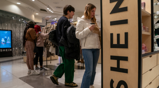 Young shoppers browsing clothes at a Shein pop-up