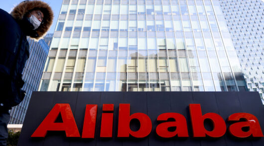 A man walks in front of Alibaba headquarters