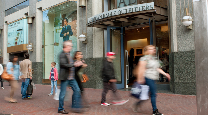 Motion blur of shoppers walking by American Eagle Outfitters storefront in Union Square, in San Francisco, CA.