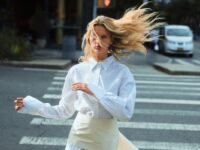 Blonde model running across a crosswalk in white shirt and tie detail belt from Beare Park 2025 campaign photoshoot