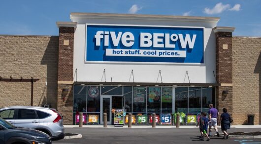 people walk in front of Five Below store in Whitestown, Indiana