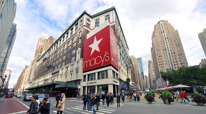 people cross the street in front of Macy's department store in New York