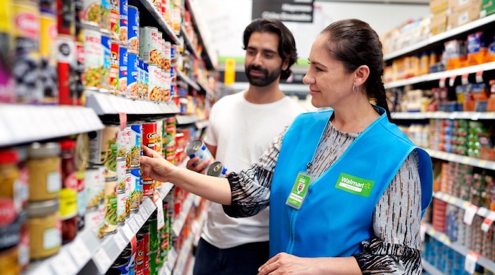 A Walmart employee using Walmart’s data insights platform Luminate to provide shopper with additional assistance.