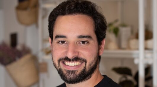 tight headshot of farm rio ceo fabio barreto in a black shirt and neutral background