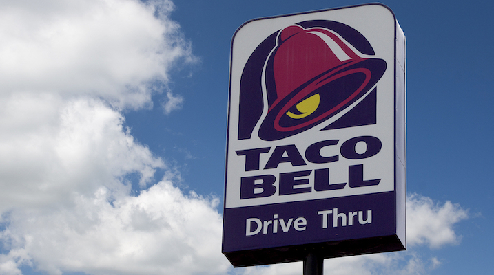 Taco Bell sign against a blue sky.