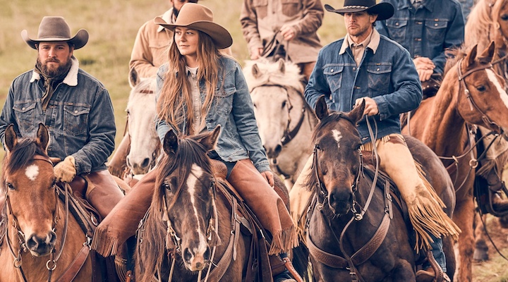 People riding horses wearing Wrangler apparel.