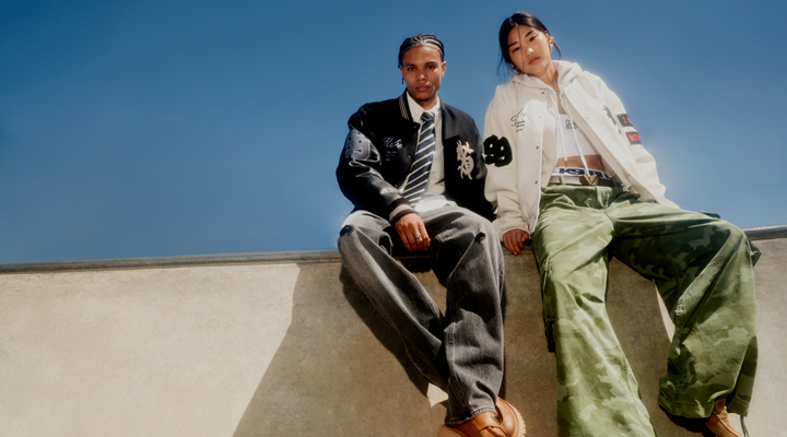 A Ksubi campaign image of two cool-looking young people sitting on a wall