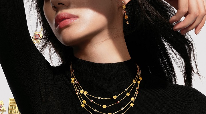 A model wears Chow Tai Fook gold necklace and earings