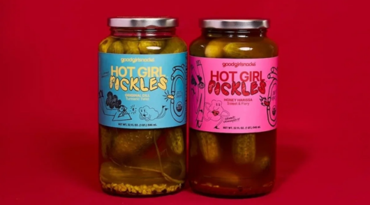 two jars of hot girl pickles against a red background