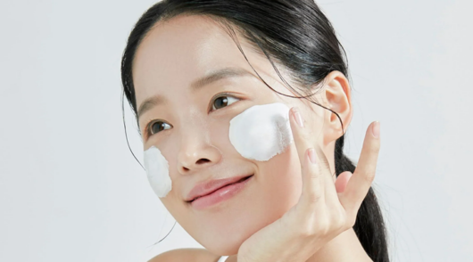 a woman uses K-beauty skincare product