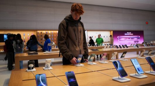 A person looks at iPhones in the Apple store