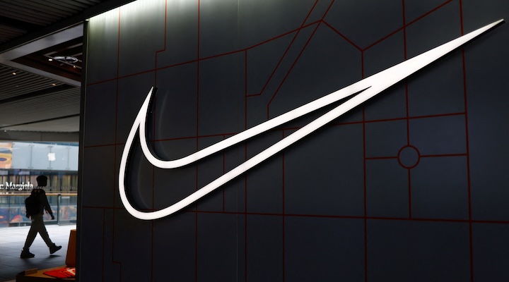 A person walks past a Nike store