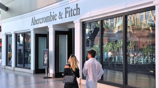 A young couple walking in front of an Abercrombie & Fitch store in Las Vegas, Nevada.