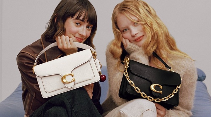 models holding Coach handbags