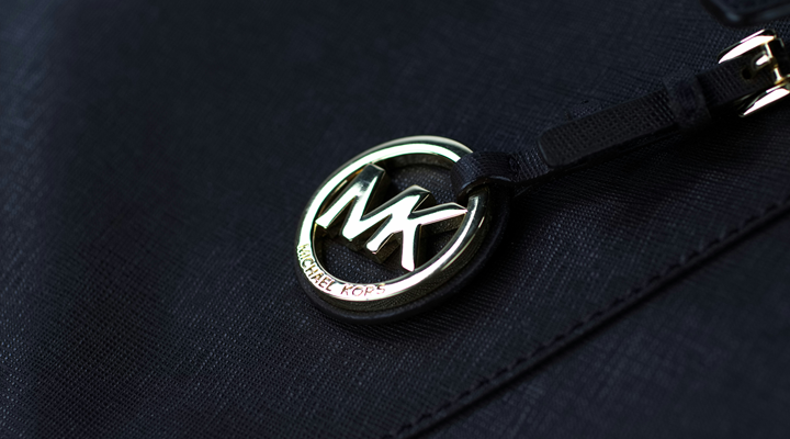 a metal michael kors tag on a purse