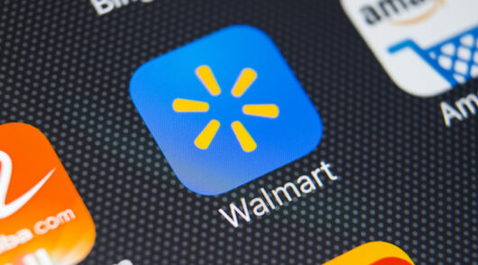 A close-up shot of a Walmart application icon on an Apple iPhone X screen.