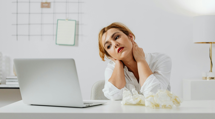 a woman staring at a laptop, out of ideas