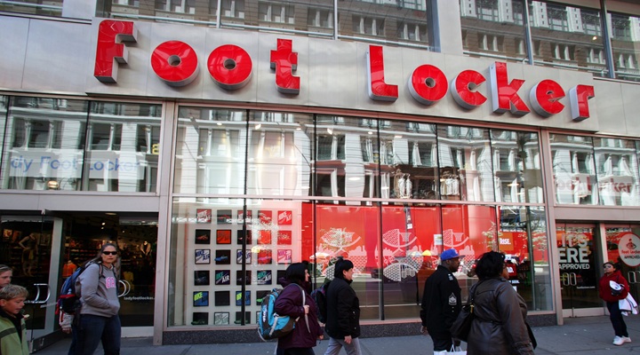 people walk in front of Foot Locker store