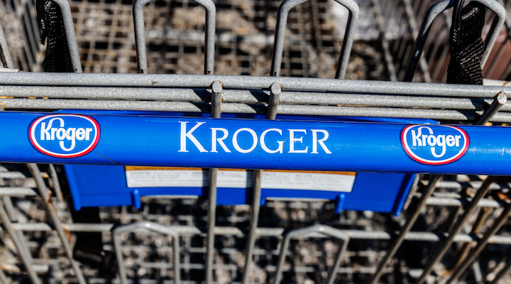 A close-up of the handle of a Kroger grocery cart.