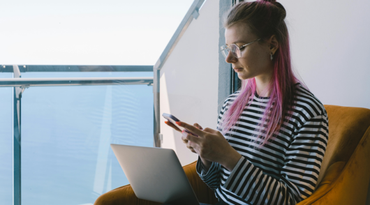 Freelancer Working Remotely with Laptop and Phone