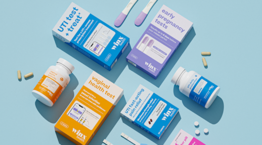 Several Winx Health products, including items like a pregnancy and UTI test, placed against a pale, blue background.