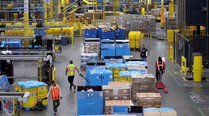 Workers move products during Cyber Monday at the Amazon's fulfillment center
