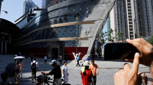 People take photos of the new Louis Vuitton store in Shanghai, China
