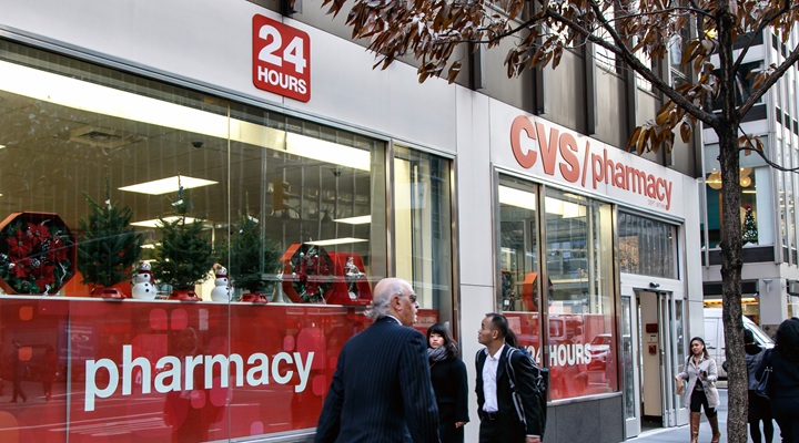 people walk in front of CVS pharmacy