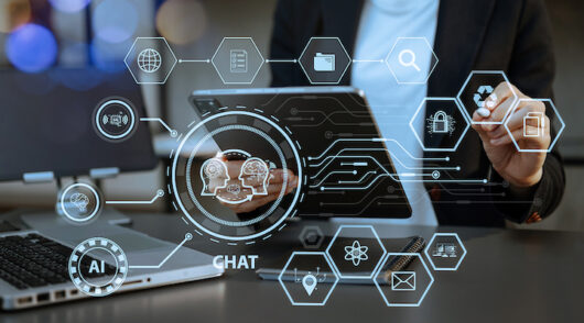 A woman sitting behind a laptop with several AI-themed icons floating in front of her.