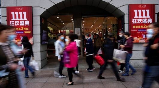 People walk along a main shopping area during the Alibaba's Singles' Day