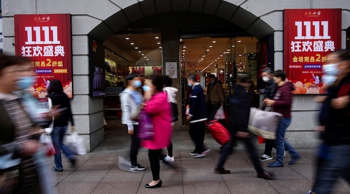 People walk along a main shopping area during the Alibaba's Singles' Day