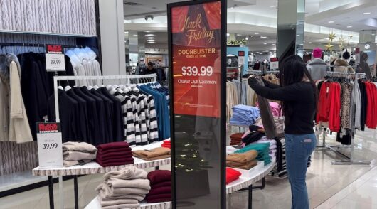 An employee folds clothes at a Macy's department store