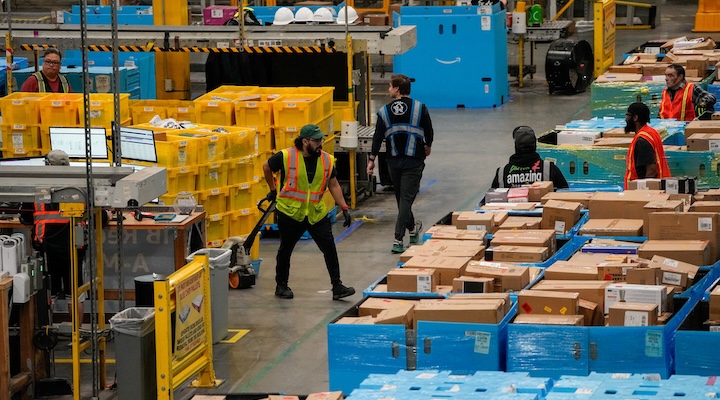 Workers move products during Cyber Monday at Amazon's fulfilment center