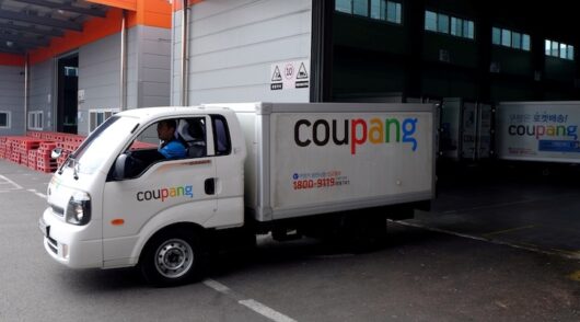 Delivery trucks for e-commerce retailer Coupang leave a distribution centre in Seoul