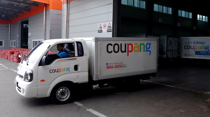 Delivery trucks for e-commerce retailer Coupang leave a distribution centre in Seoul