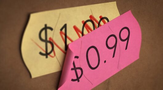 Psychological pricing printed on a pink label over a normal price.