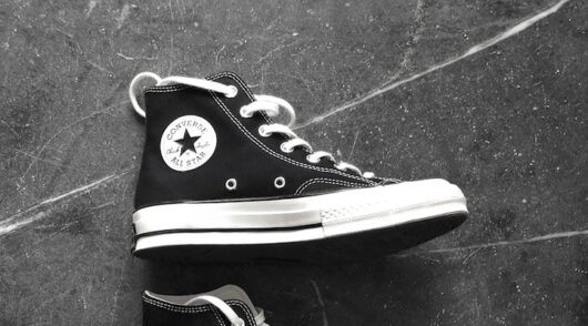 A close-up shot of a black-and-white Converse sneaker.