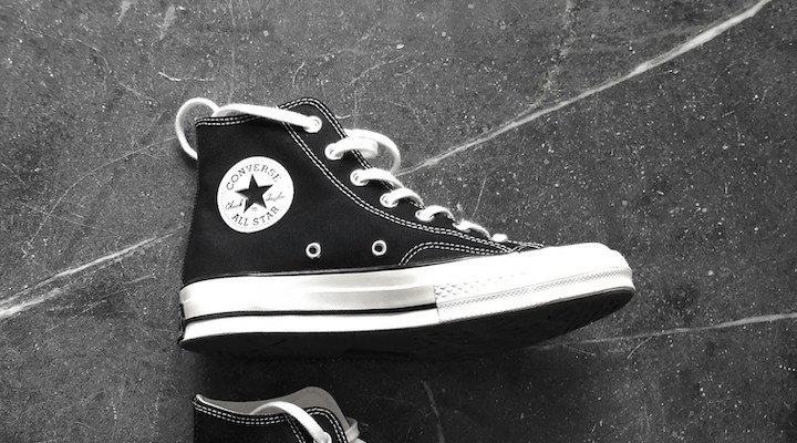 A close-up shot of a black-and-white Converse sneaker.
