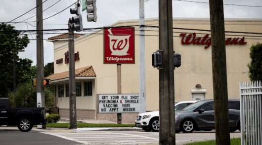 A sign advertises flu, pneumonia, and shingles vaccine shots at a Walgreens pharmacy