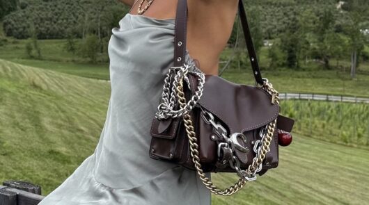 model wears a Coach bag