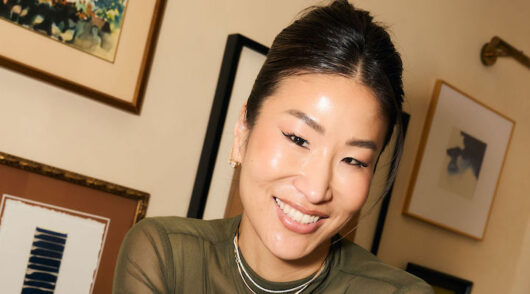 A headshot of Kinn Studio founder Jennie Kinn in a green dress.