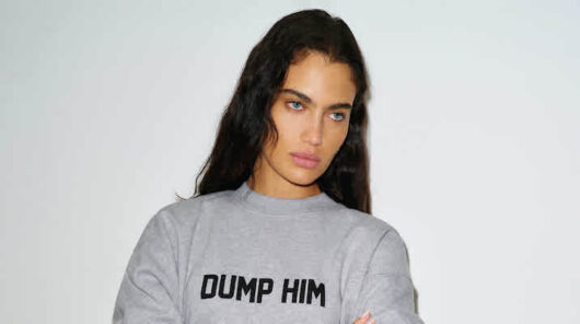 A dark-haired model wearing a sweater from Reformation’s Divorce collection.
