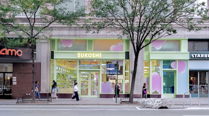 An exterior shot of a Sukoshi Mart storefront.