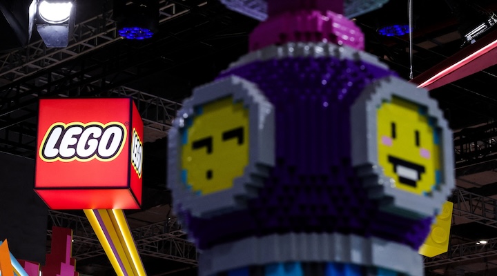 A logo of Lego is displayed next to an installation at the company’s booth at the 8th China International Import Expo (CIIE) venue